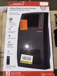 Lasko 1500-WATT 20 In. Black Electric Heater With Adjus Louvers, Timer, Remote. Fixed Price $80.00.